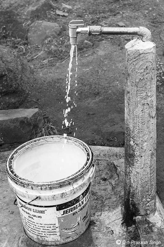 Optimizing traditional drinking water sources for accelerating change - household tapstand supplying the water from the innovative spring-based well inside Paharia Tola, village Jhajhapara, district Dumka, Jharkhand